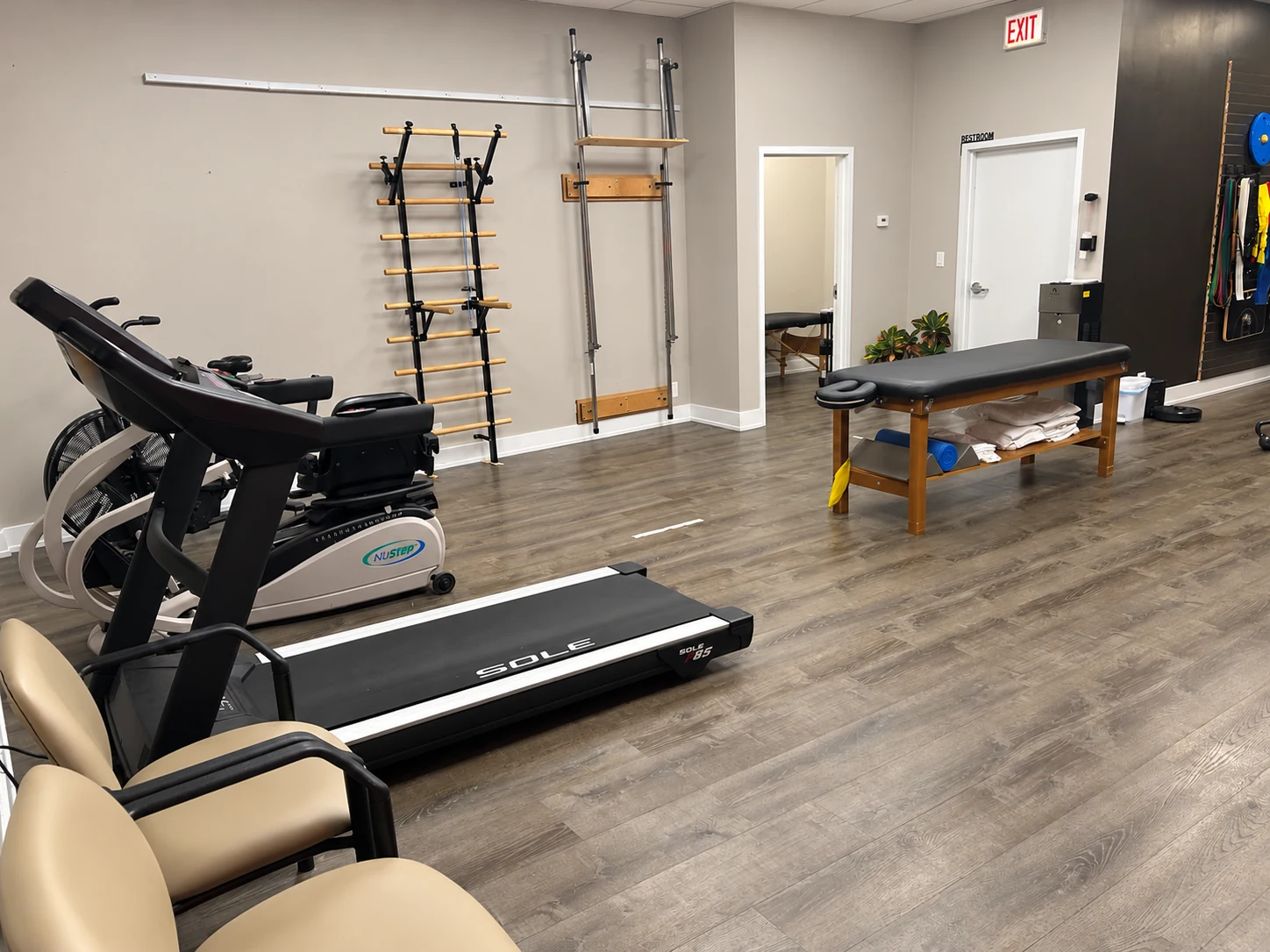 MILO's exercise area with cardio equipment and weights